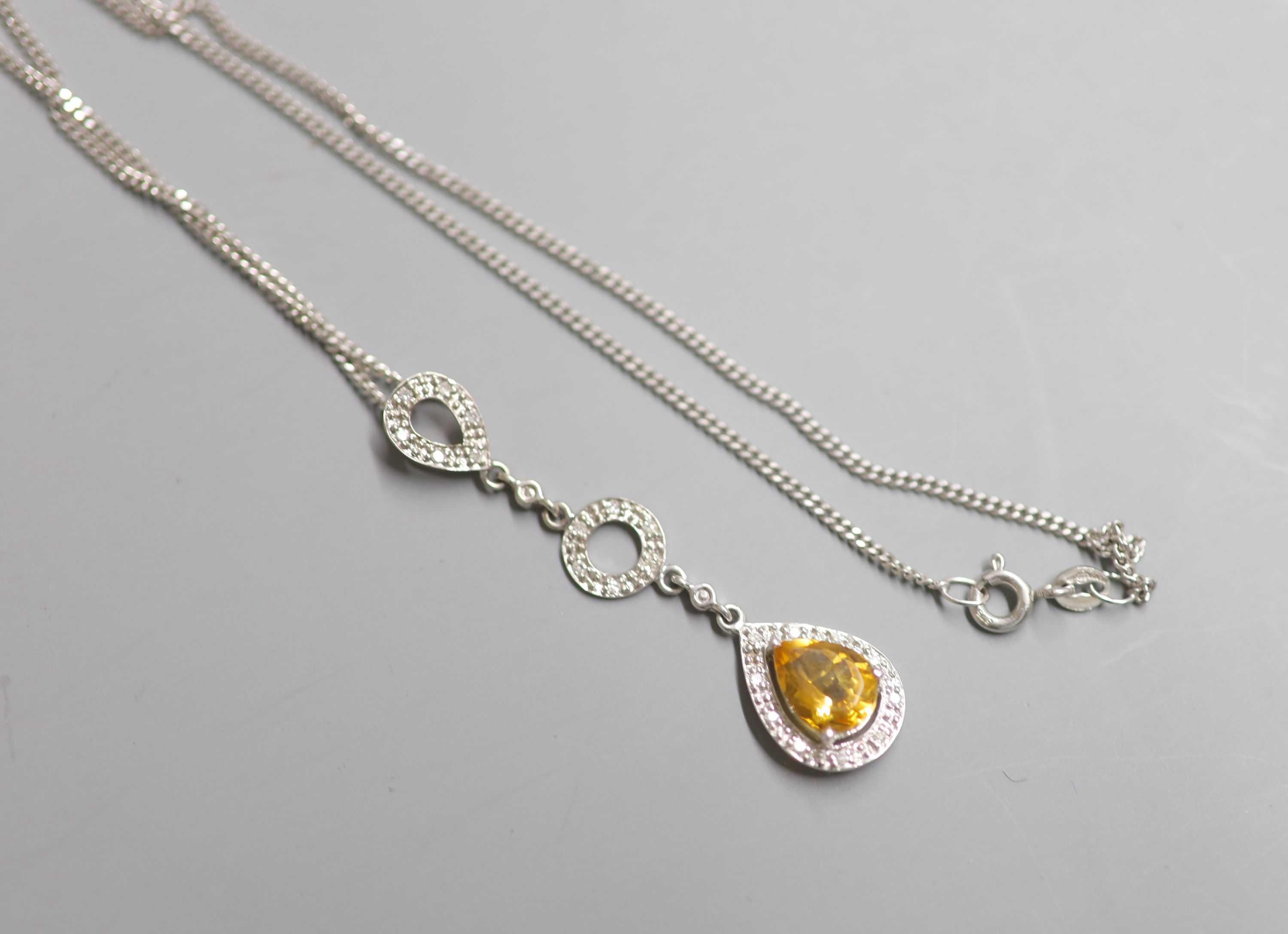A modern 9ct white gold, pear shaped citrine and diamond cluster drop pendant, on a 9ct white gold chain,